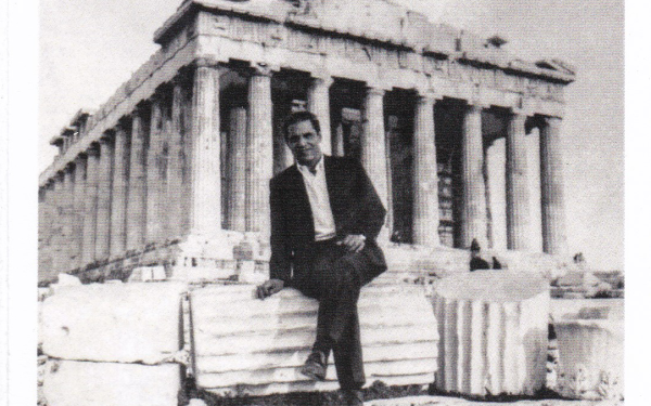 Thomas Anderson as a young man sitting on columns in front of the Parthenon in Greece