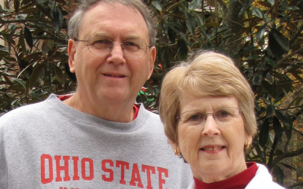 Mike and Cindy Morgan smiling at the camera. Mike is wearing an OSU sweatshirt and Cindy is wearing a Wittenburg sweatshirt.