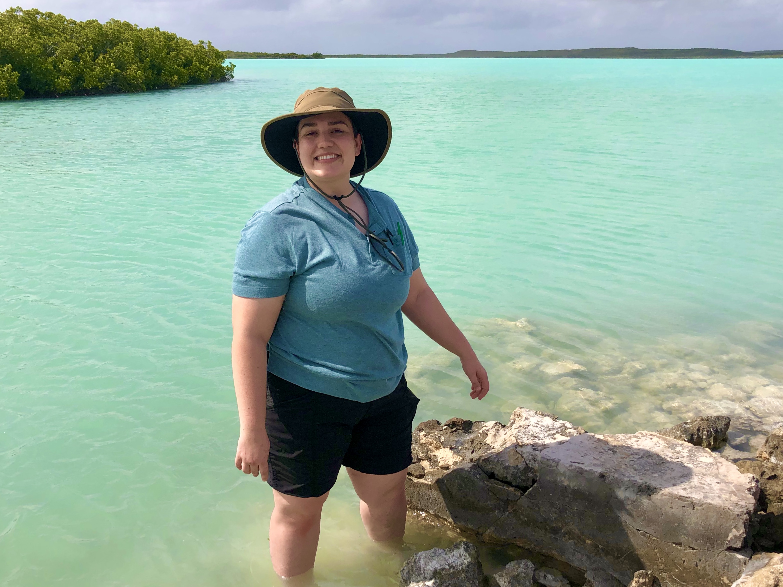 Casey smiling at the camera standing in a lagoon