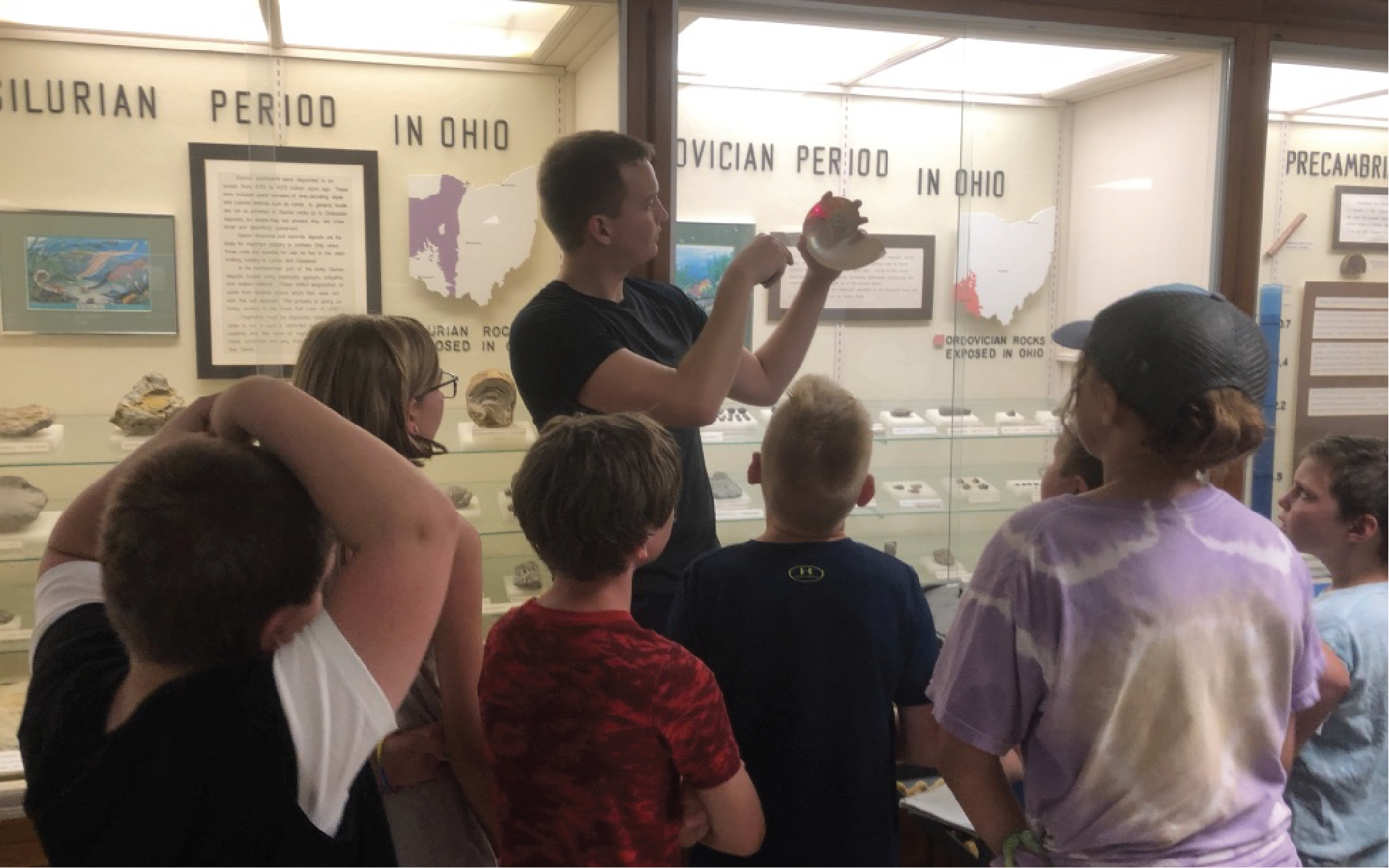 PhD student Ken Peterman teaches school children about fossils in the Orton Geological Museum