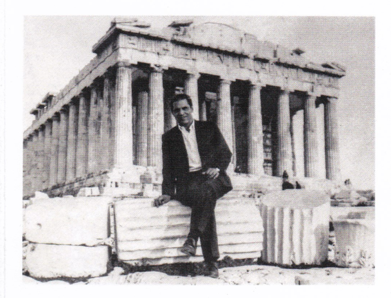 Thomas Anderson as a young man sitting on columns in front of the Parthenon in Greece