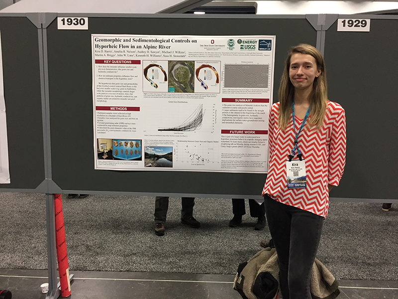 Kira Harris standing next to her research poster