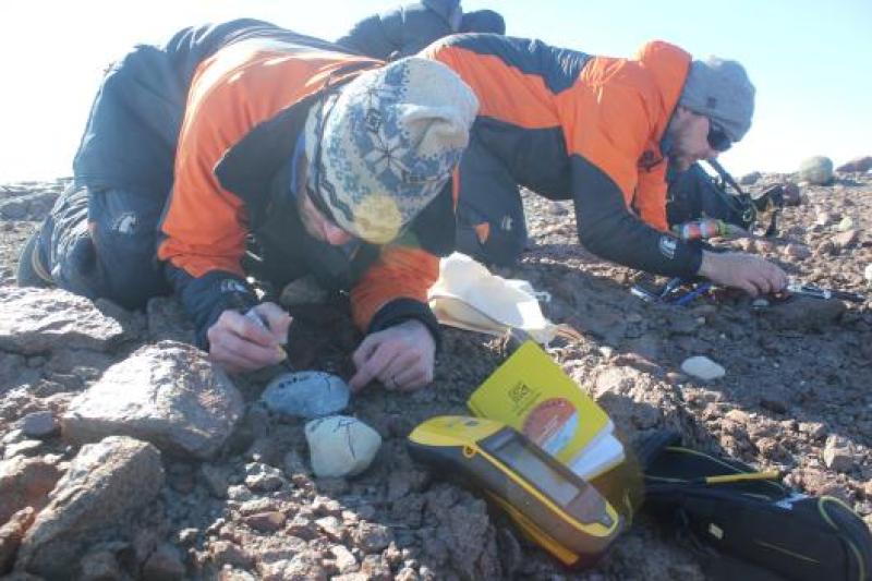 Shaun Eaves and Jamey Stutz mark samples and record critical site information for a set of samples collected along the Lonewolf Nunataks, upper Byrd Glacier
