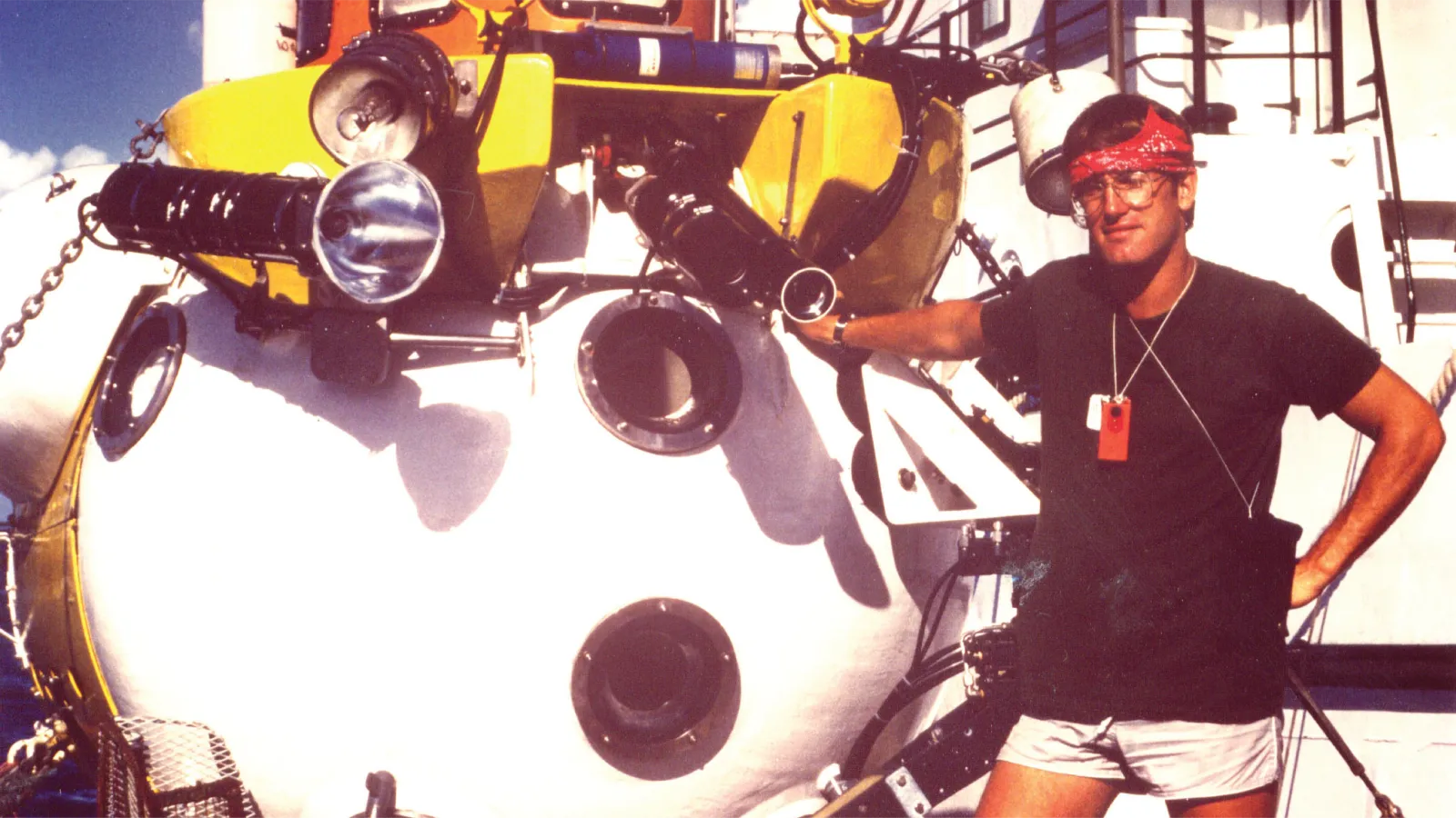 Robert Couch leans up against field equipment
