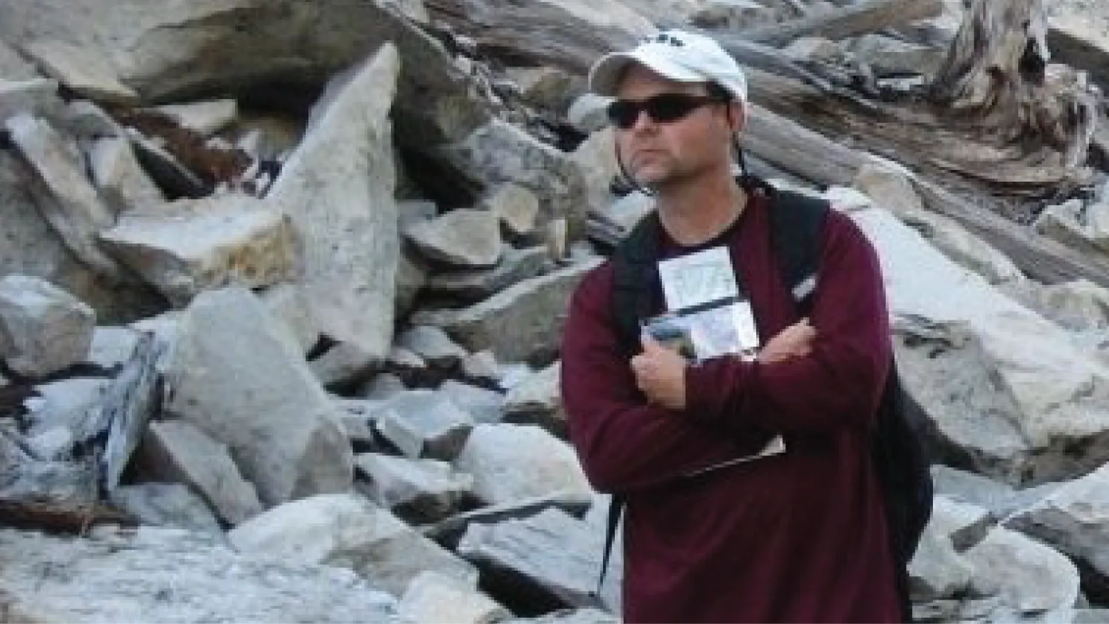 Warner Cribb in front of an outcrop