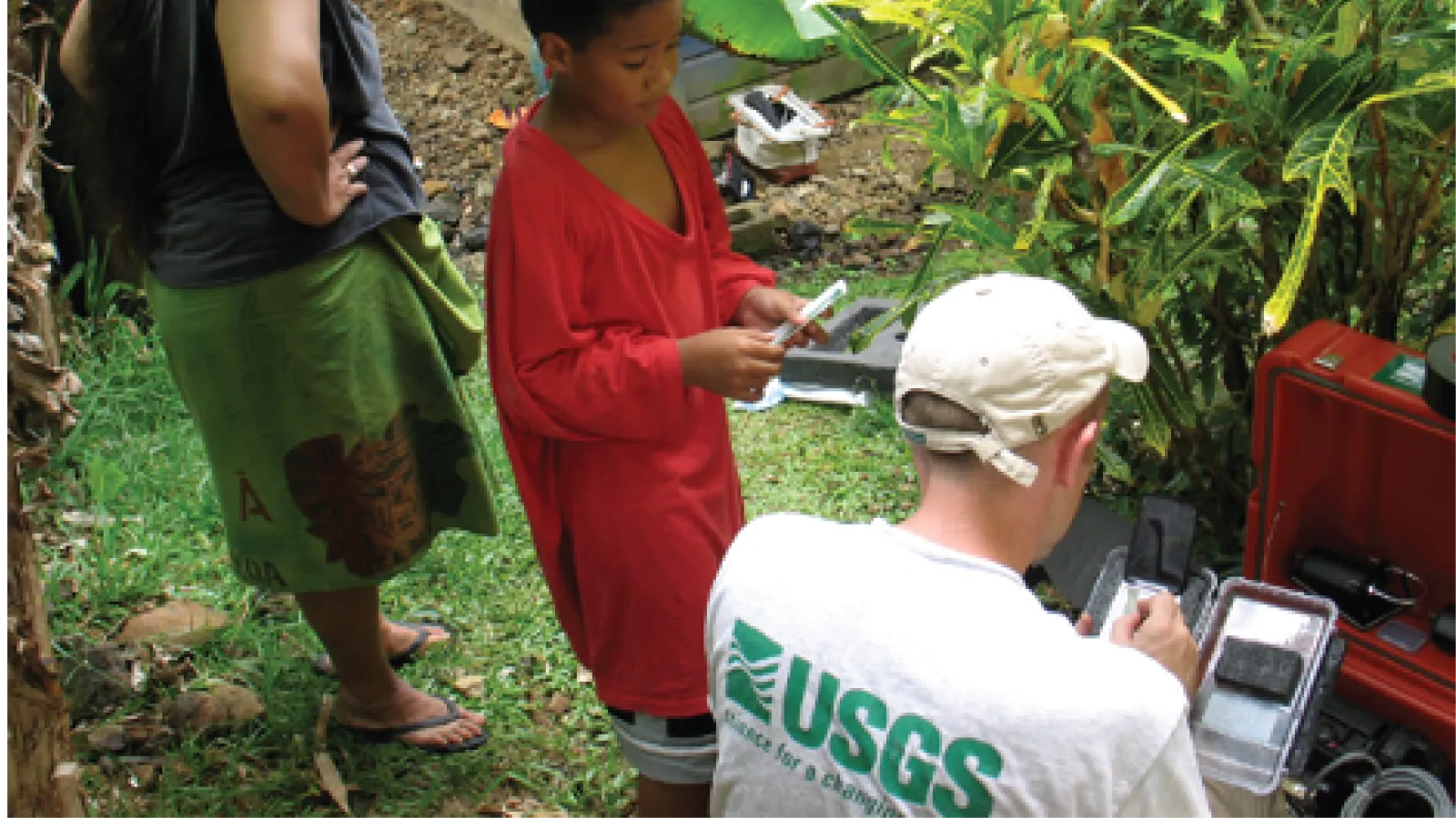 Jeff Fox working in Asia wearing a US Geological Survey shirt
