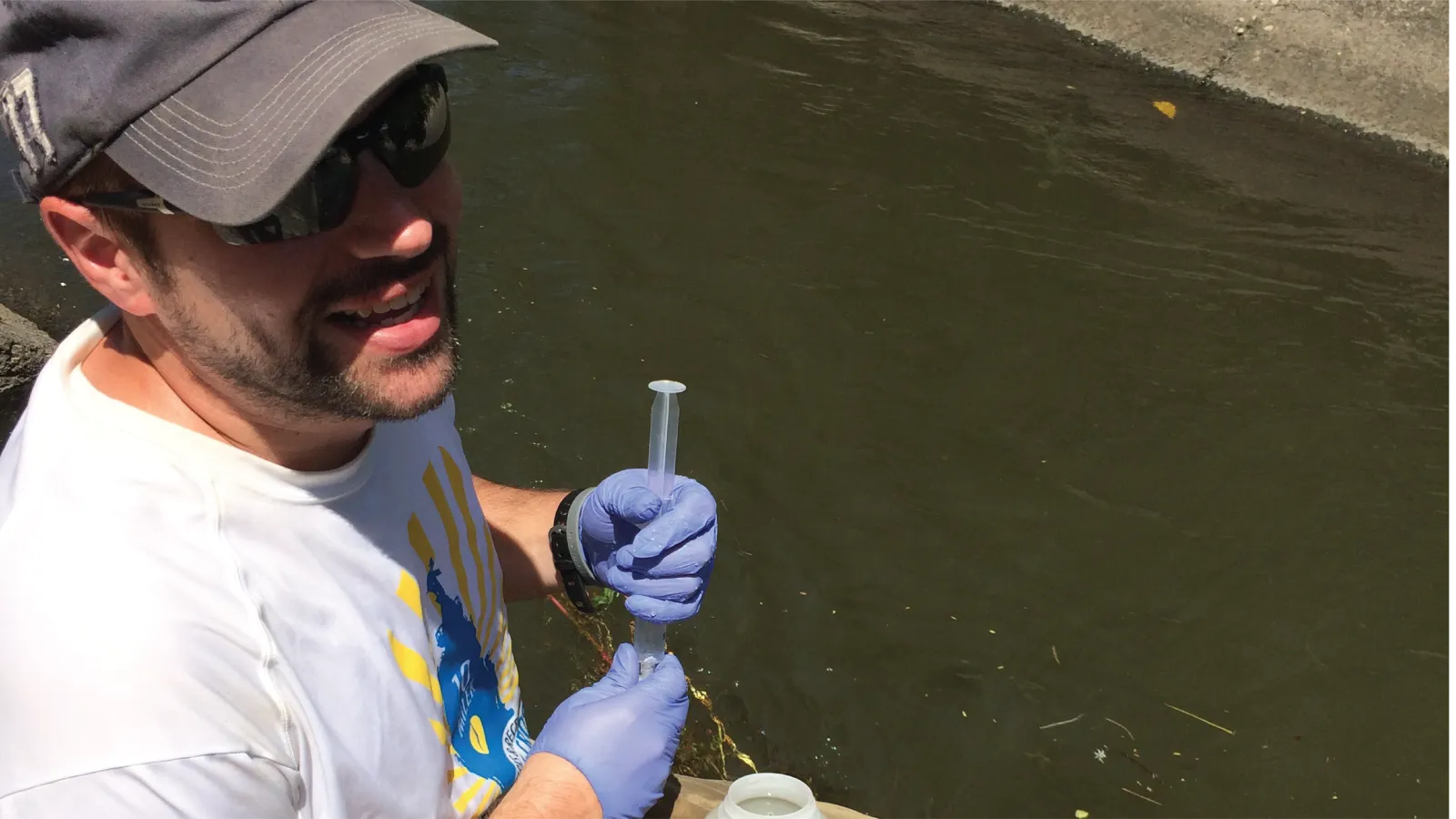 Steve Goldsmith sampling a body of water