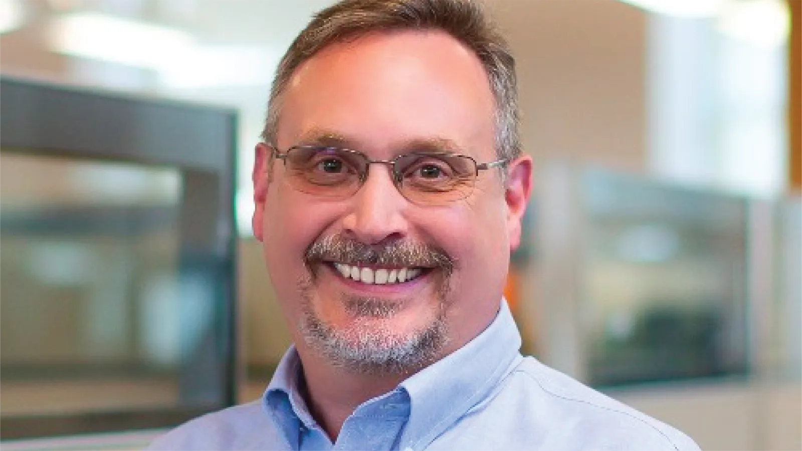Doug Kilmer smiling in front of a lab