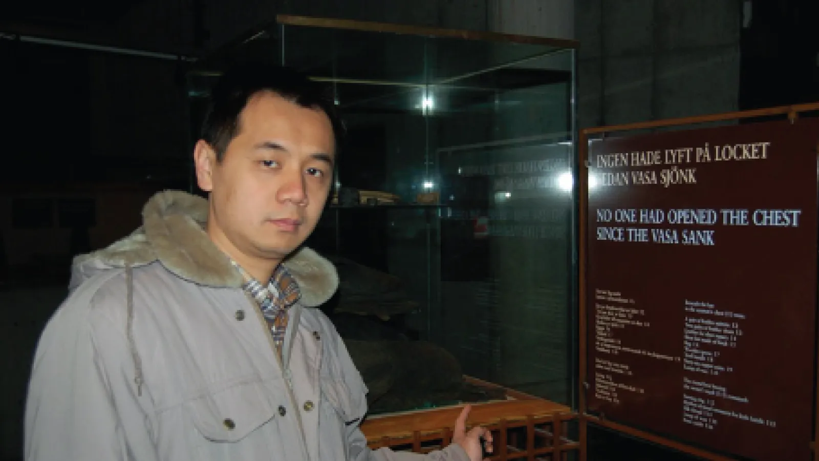 Alex Lin wearing a coat inside of a building