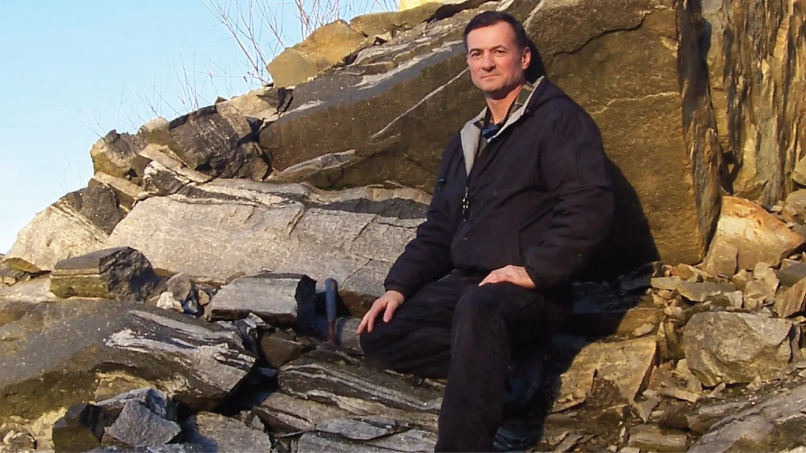 Kevin Richardson leans against a rock formation