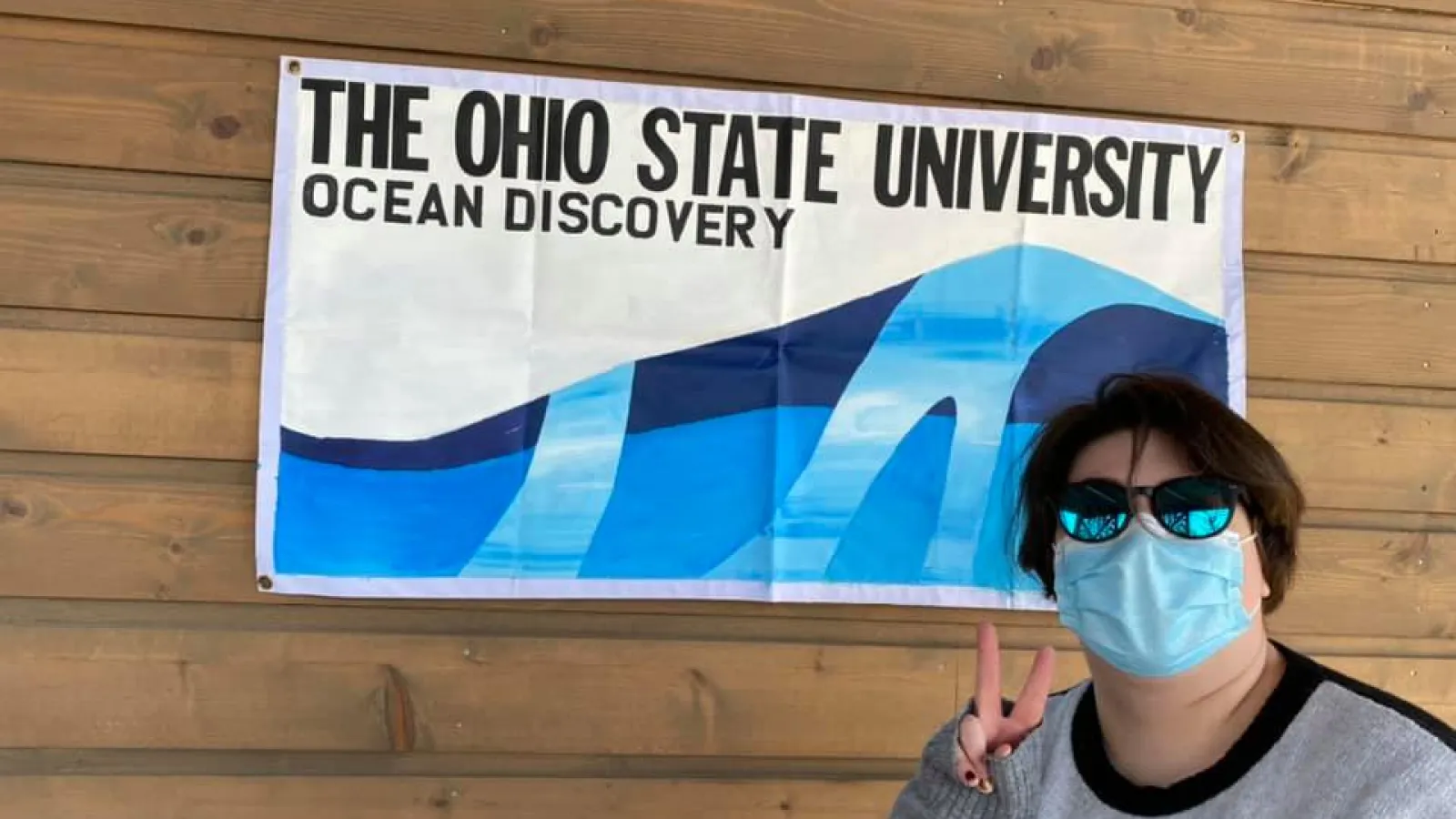Susie in front of sign