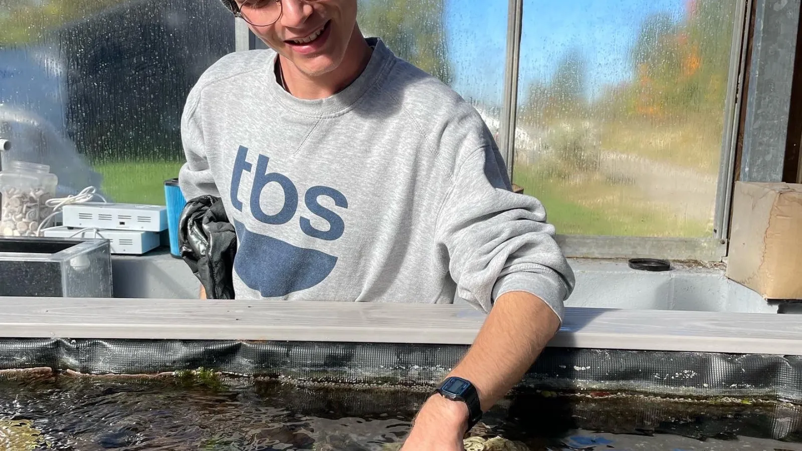 Student looking at coral tanks at Reef Systems