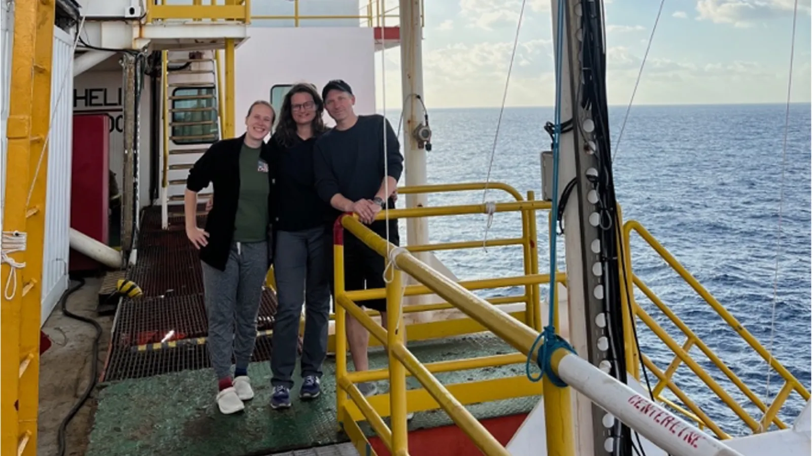 Cook, Coyte, and Sawyer standing on research vessel