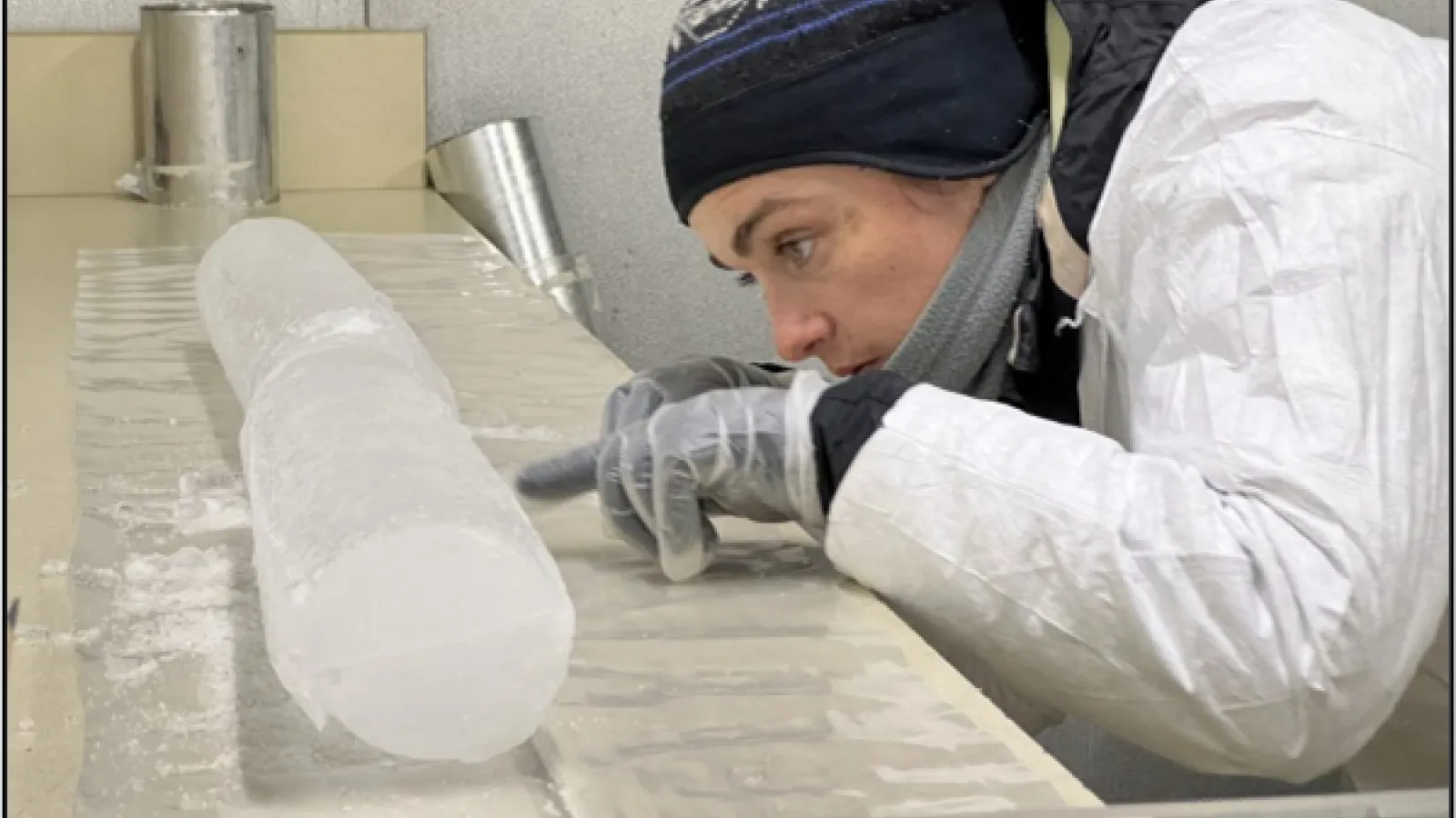 Emilie in the BPCRC cold room, observing the visual stratigraphy of the Huascarán ice core.