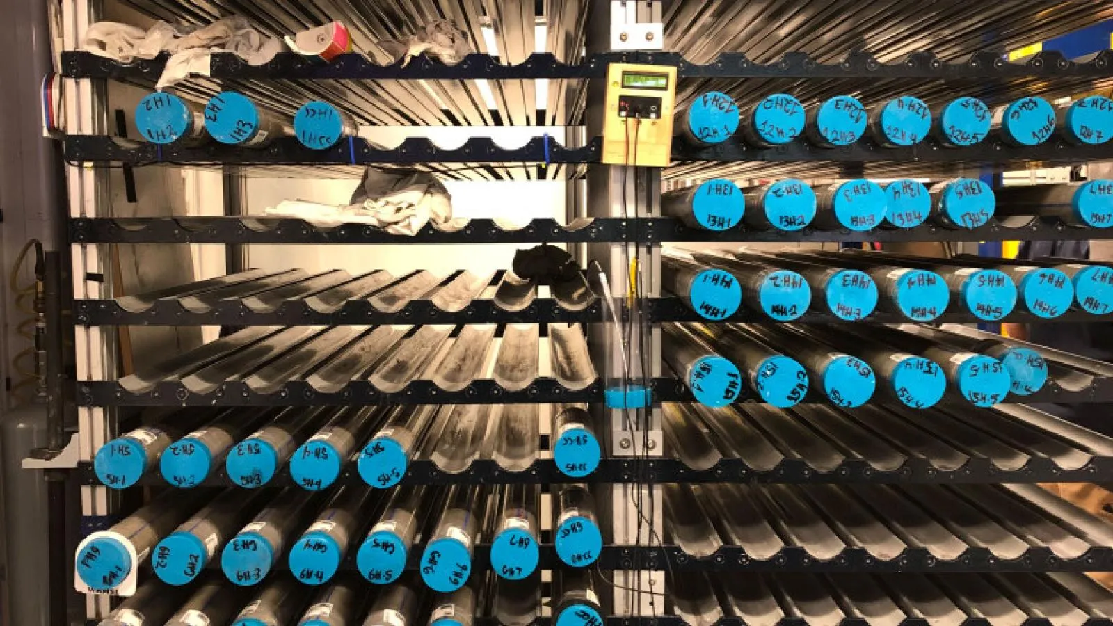 Core racks filled with whole-round core sections waiting to be analyzed and split. (Credit: Maria Filomena Loreto &amp; IODP JRSO)