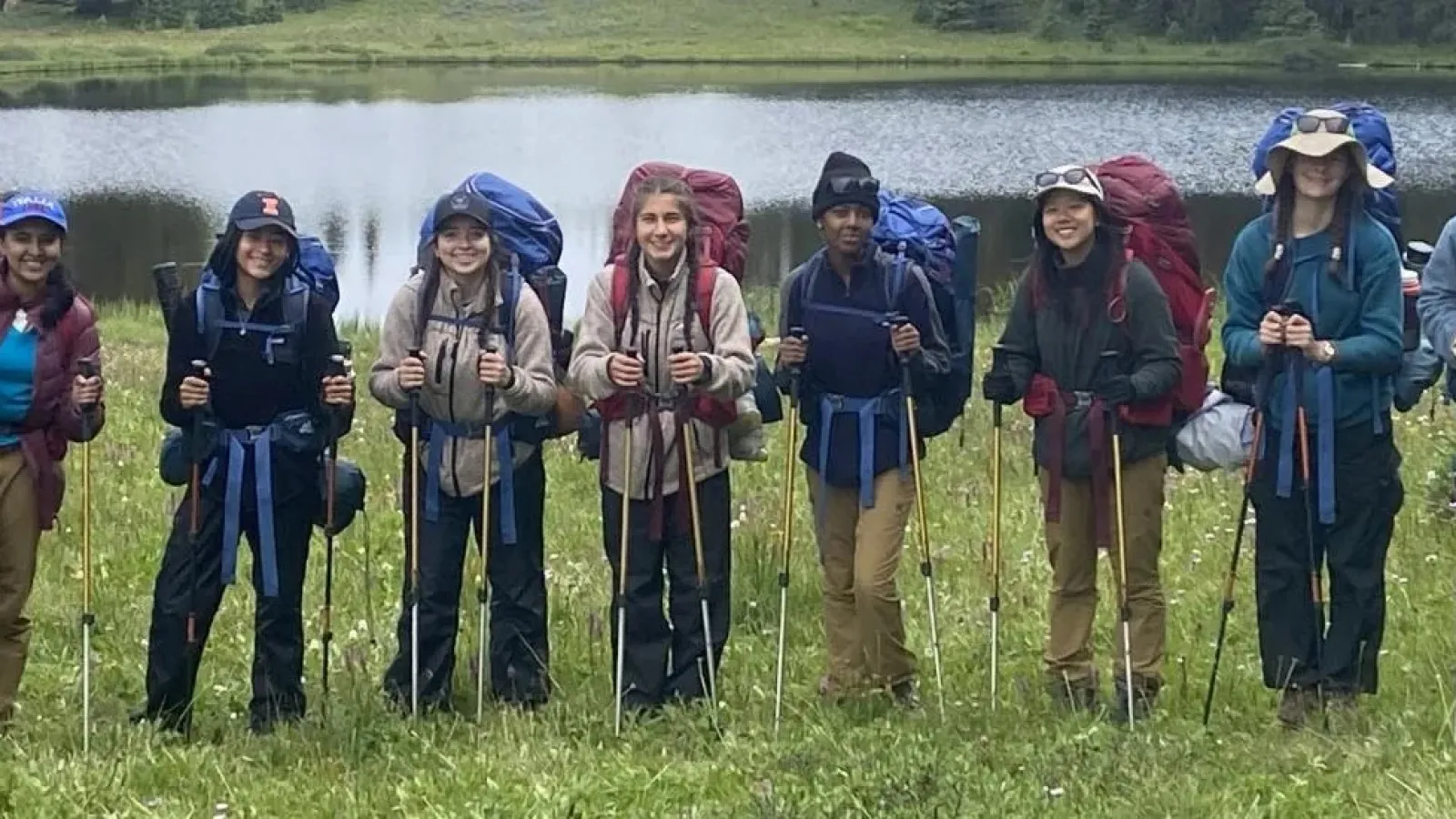 Girls* on Rock participants pose at their basecamp in the backcountry