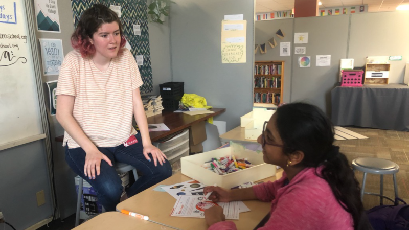Alum Brittan Wogsland leads an outreach activity at a local middle school.