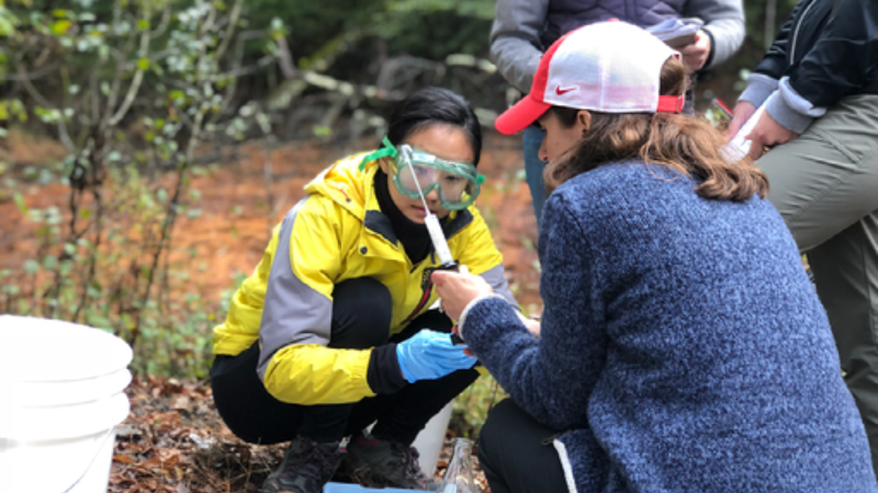 Alum Dr. Ji-Eun Kim and Professor Liz Griffith test water samples during a field trip for the Introduction to Geochemistry course.