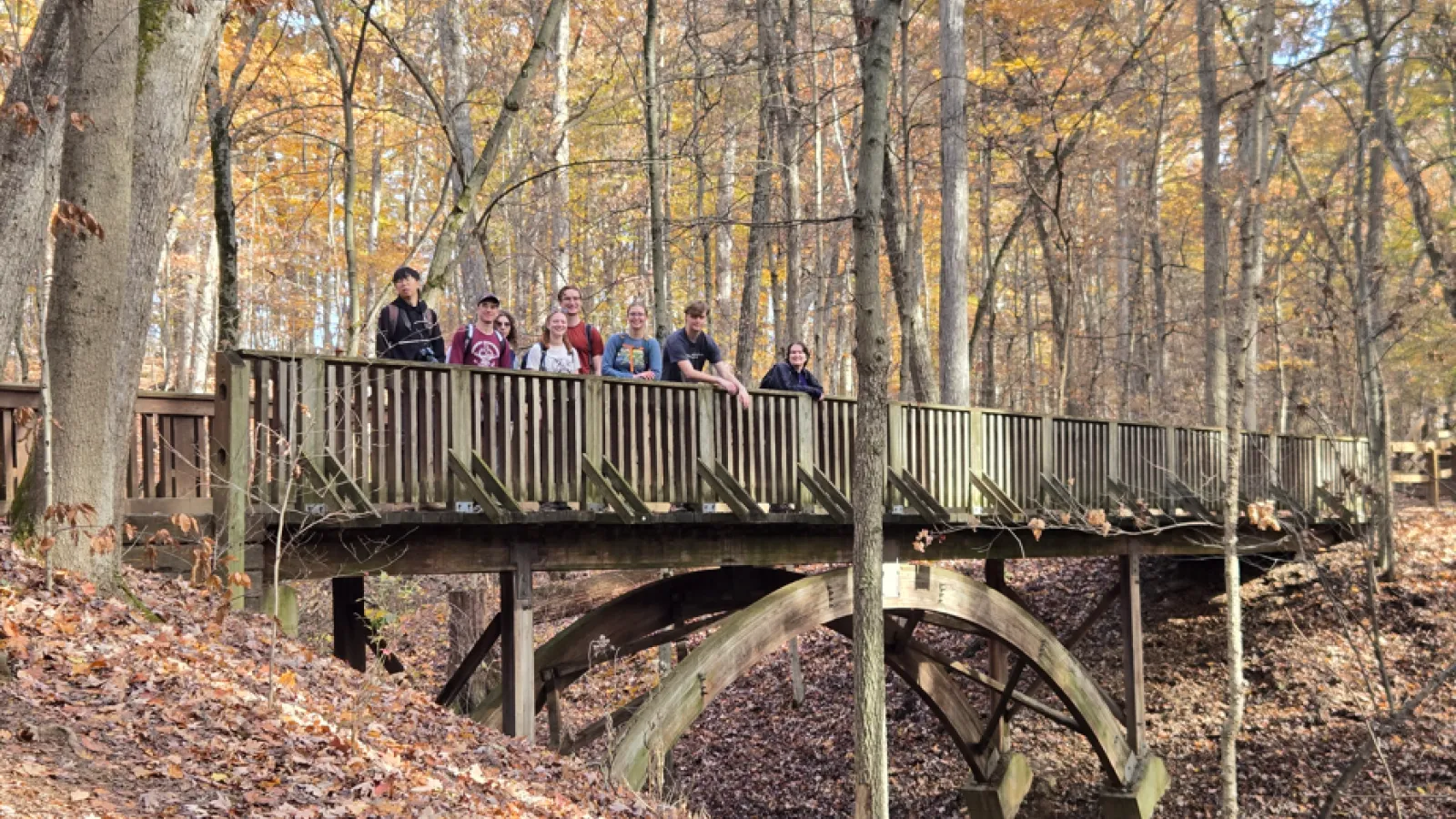 The Geology Club enjoys the fall foliage at Highbanks Metro Park from a bridge.