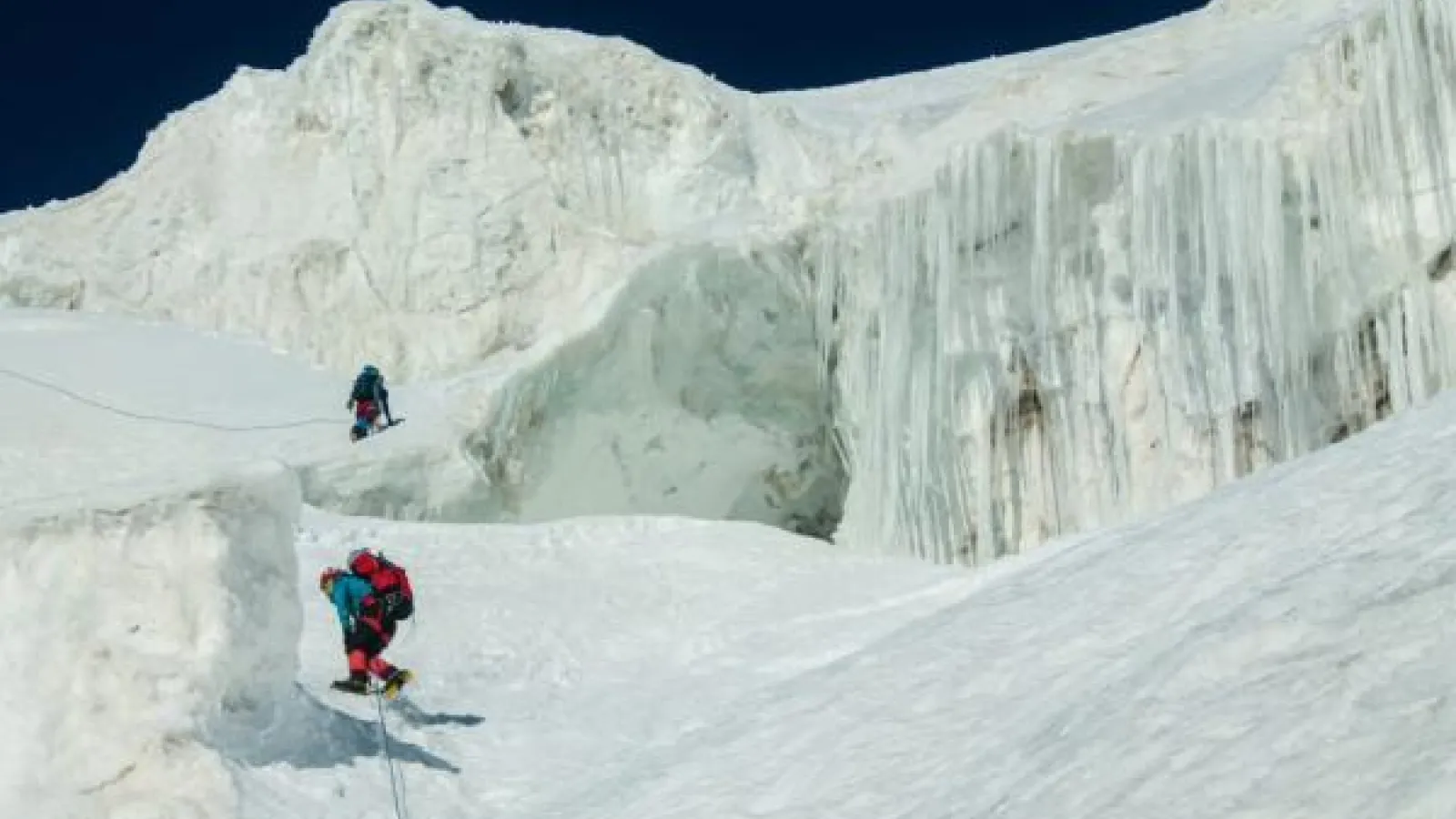 Two polar explorers climbing an icy landscape