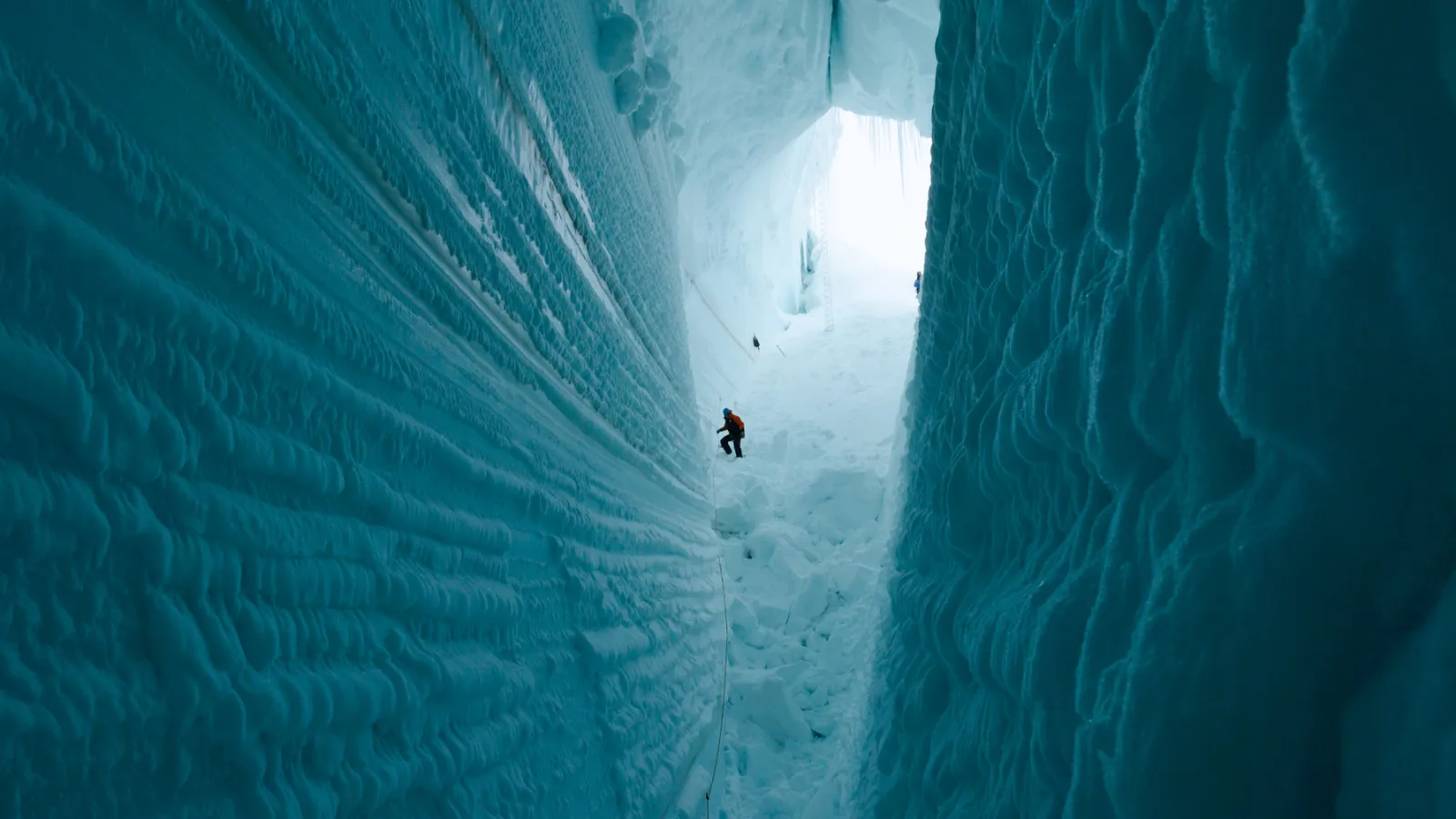 inside a glacier crevasse with a climber