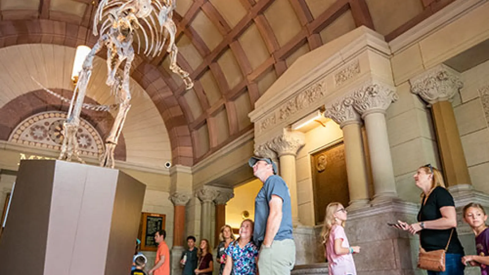 Visitors admire cryolophosaurus at open house. Photo Credit: Mark Schmitter