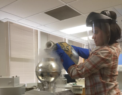 Graduate student Teresa Avila pours liquid nitrogen into an instrument