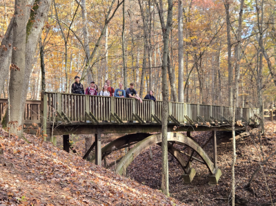 The Geology Club enjoys the fall foliage at Highbanks Metro Park from a bridge.