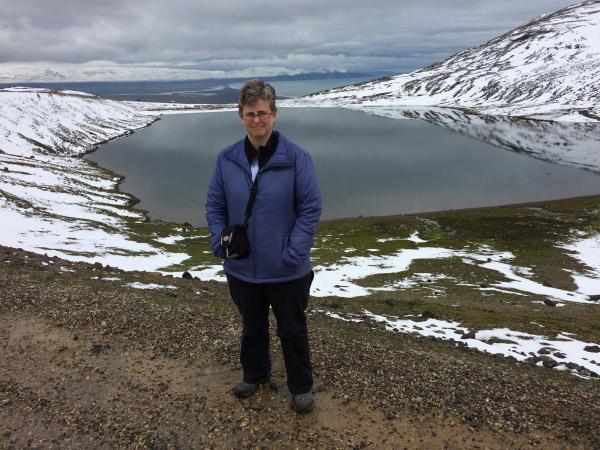 Alum Katie Lewandowski smiles in a snowy mountain terrain