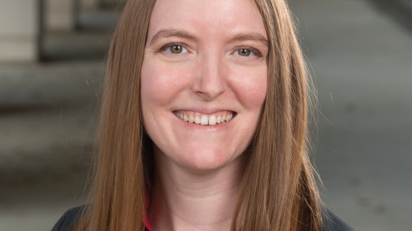 Dr. Laura Lukes smiling in a suit