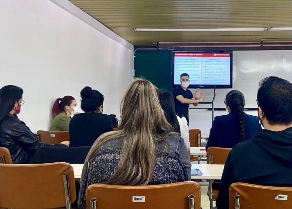 A man presenting in a class room