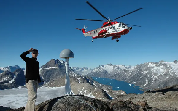 a student in Greenland with a helicopter in background