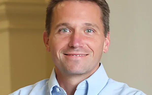 Professor Derek Sawyer smiling with arms folded