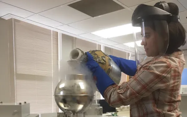 Graduate student Teresa Avila pours liquid nitrogen into an instrument