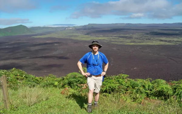 SES Alum Dan Kelley on the rim of the crater at the Sierra Negra Volcano; Isabela Island, Galapagos Islands