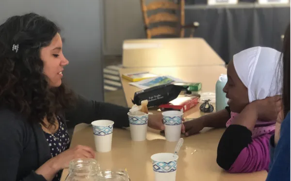 SES PhD graduate Melisa Diaz teaches a student an atmospheric-science related activity