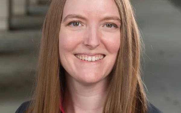 Dr. Laura Lukes smiling in a suit