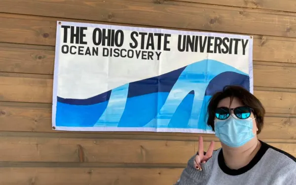 Susie in front of sign