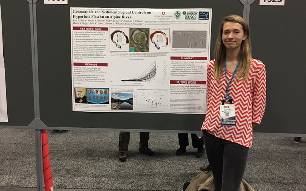 Kira Harris standing next to her research poster