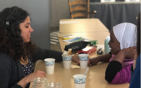 SES PhD graduate Melisa Diaz teaches a student an atmospheric-science related activity