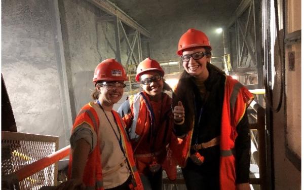 Trio of students smiling at the camera in the salt mines