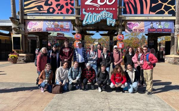 Group photo in front of the zoo sign