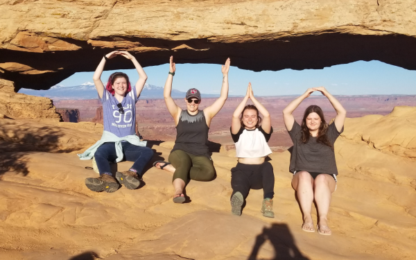 Students and teaching assistants at Arches National Park during field camp make an O-H-I-O.