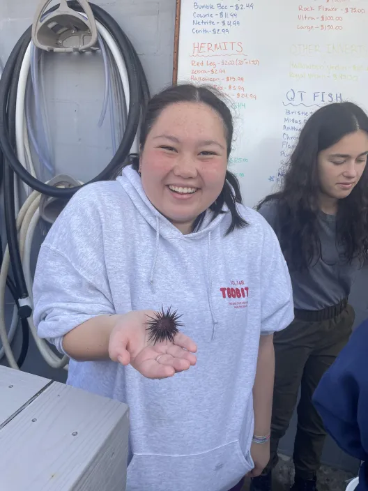 So happy to hold a sea urchin at the Reef Systems Coral Farm