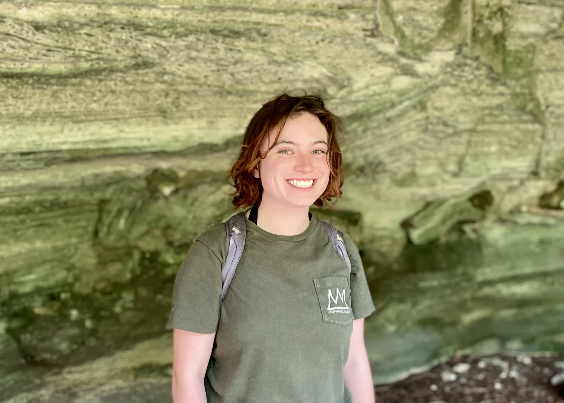 Lily smiling in a cave
