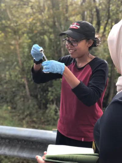 Student performing a geochemistry experiment