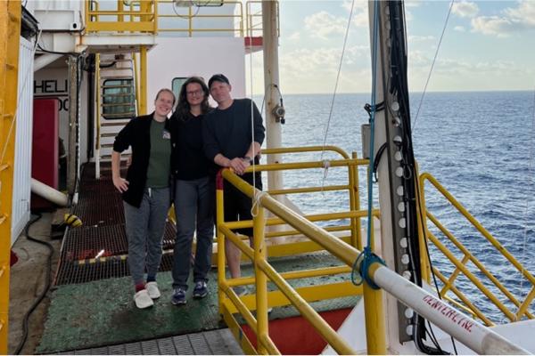 Cook, Coyte, and Sawyer standing on research vessel