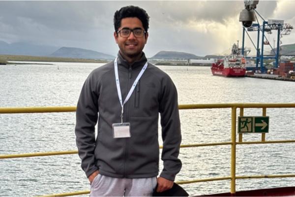 Graduate student Fawz Naim standing on a research vessel