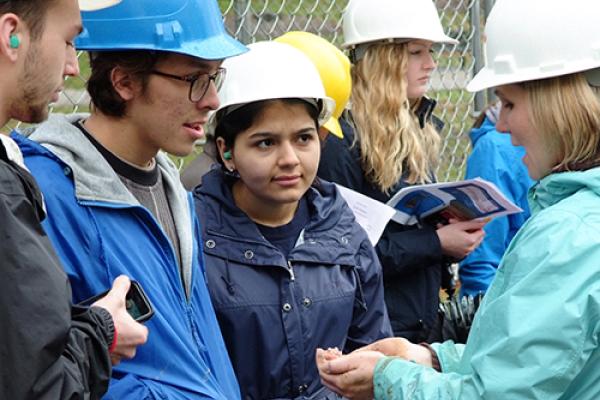 Photo of students in Water Issues class learning how to describe cuttings from the well that was drilled on campus