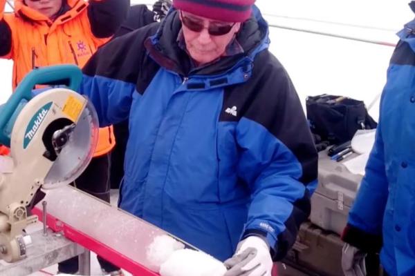 Professor Thompson cuts fresh ice core Professor Thompson cuts fresh ice core